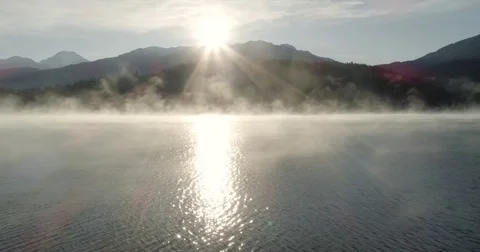 Sun Rising Over Mountains and a Mist Covered Lake Video stock 82808178