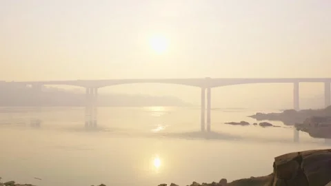 The sun rising over the river on a hazy day. Stock Footage 329143941