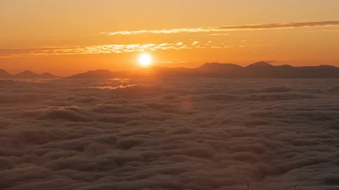 The Sun rising over a Sea of Clouds (time lapse/zoom in) Stock Footage 119513723