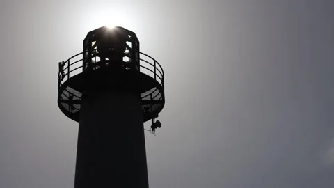 Sun Rising Over Silhouette Of A Lighthouse Stock Footage 337679597