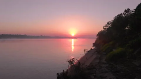 Sun rising over tropical Amazon rainforest and Madre de Dios river Stock Footage 135577468