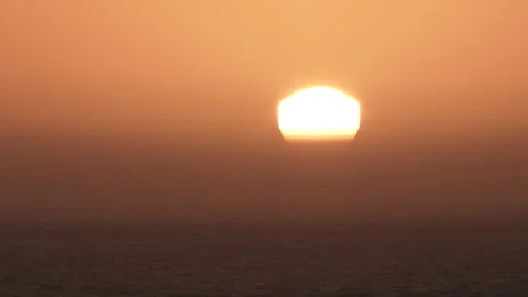 Sun Rising Through Polluted Haze Over Water Video stock 254806988