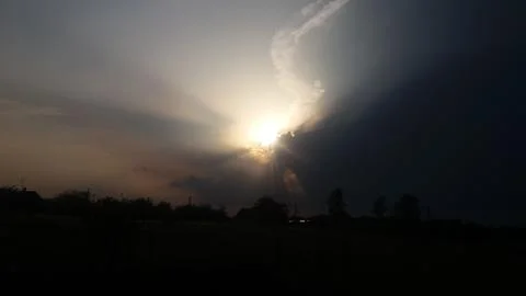The sun s rays shine from behind the clouds Stock Photos