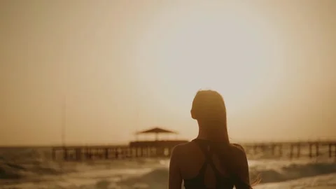 Sun Salutation. A young woman does Surya Namaskar at sunset.  Stock Footage 196613859