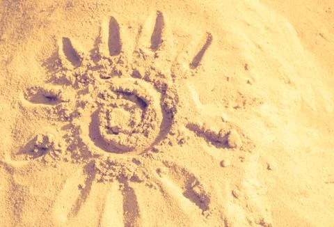 Sun, sand, warm, abstract background. Summer, the sun drawn in the sand.. Stock Photos
