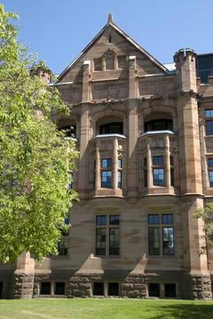 Sun on sandstone eastern facade  of old building on an Spring morning. Fotos de archivo