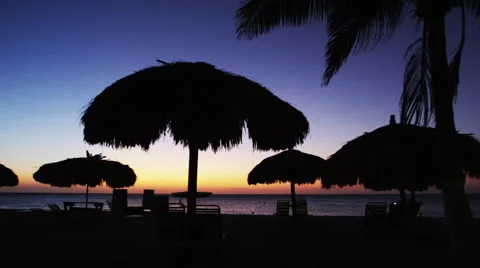 Sun Set after glow with Native Beach Umbrellas Video stock 52235104