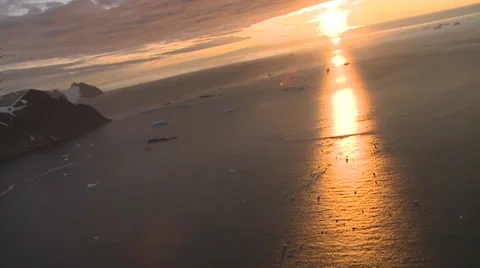 Sun set, beautiful light Antarctic sea dotted with glowing bergs Stock Footage 34313597