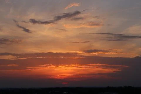 Sun set behind the clouds. Stock Photos