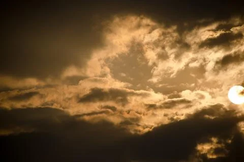 Sun set in dark clouds Stock Photos