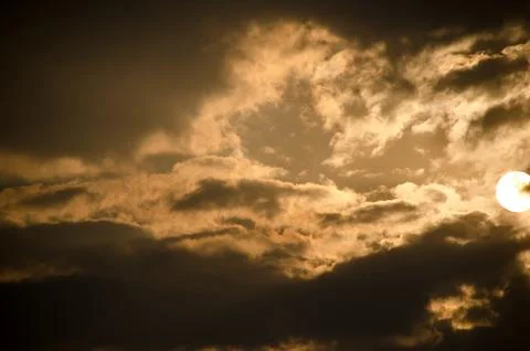 Sun set in dark clouds Stock Photos