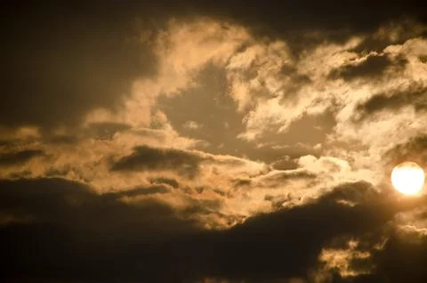 Sun set in dark clouds Stock Photos