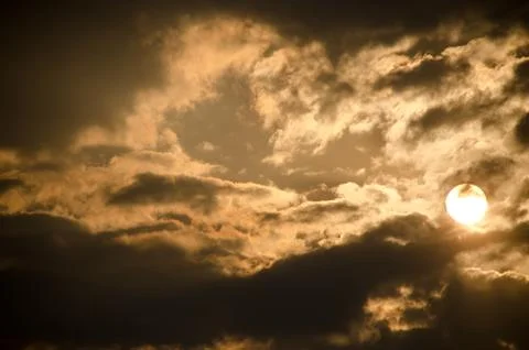 Sun set in dark clouds Stock Photos