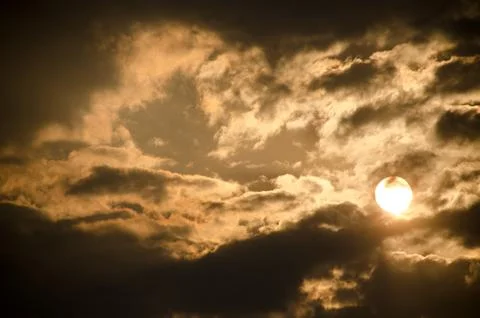 Sun set in dark clouds Stock Photos