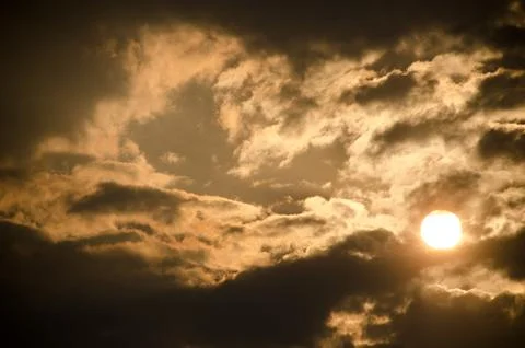 Sun set in dark clouds Stock Photos