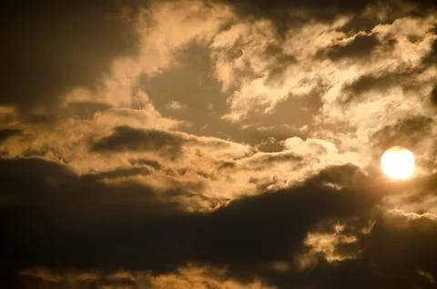 Sun set in dark clouds Stock Photos