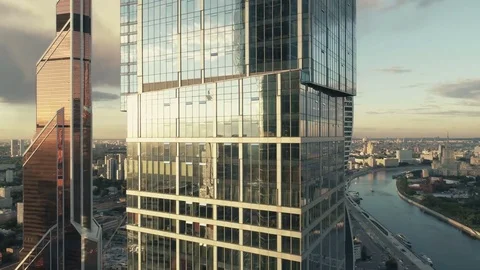 A sun set drone Aerial shot of skyscrapers of  business centre, 4K Ultra HD real Video stock 83493113