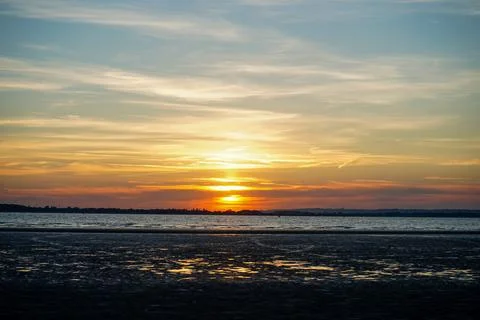 Sun set over a sandy beach and ocean in England 库存照片