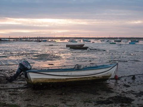 Sun set sky dramatic clouds sea front beach harbor marina boats moored landsc Stock Photos