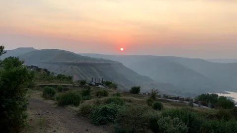 Sun set view of the mountains and lake from Sajjangad fort in Satara Stock Footage 83445815