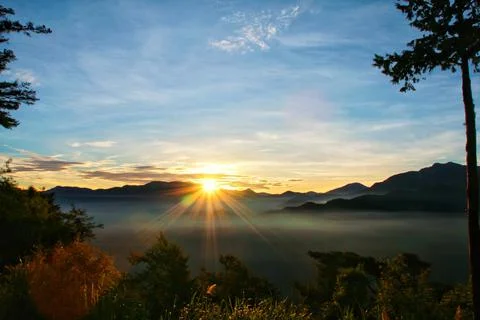 Sun set view over mountains with fog on floor ground in the morning. Alishan  Stock Photos