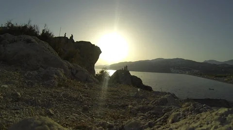 Sun sets and kids cliff dive Stock Footage 30578634