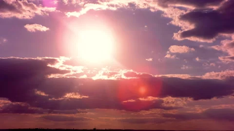 The sun sets beautifully behind the passing clouds. Bright scarlet sunset.  Stock Footage 142080264