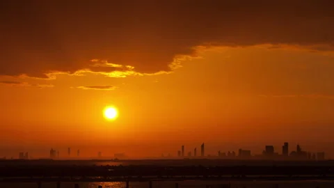 Sun Sets Behind Abu Dhabi Skyline Seen From Yas Island Vídeos de archivo 345090520