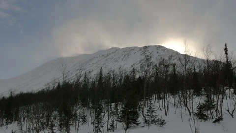 Sun sets behind big white hill covered with thick snow Video stock 109718956