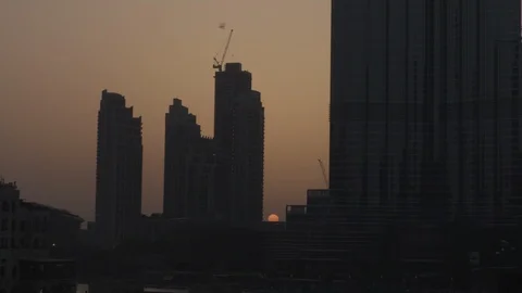 Sun Sets Behind Burj Khalifa 4K Stock Footage 89501601