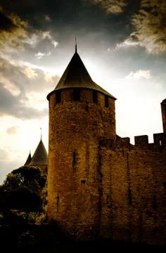 The sun sets behind the Chateau Comtal in the medieval Cité de Carcassonne Stock Photos