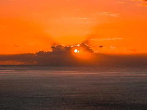 Sun sets behind clouds over the Atlantic off Madeira, Portugal Foto stock