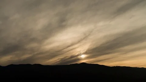 The sun sets behind a cloudy sky in Arizona. Video stock 80826607