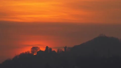 Sun sets behind the hill. Video stock 149551216
