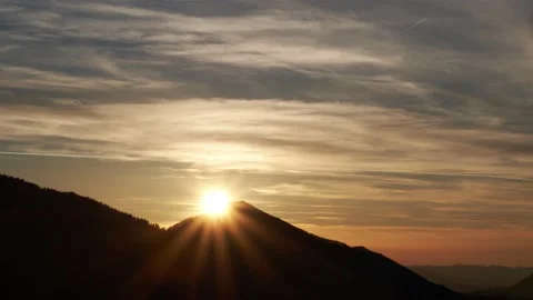 The sun sets behind the hill, the sun's rays, the orange horizon, the clouds 스톡 동영상 169599874
