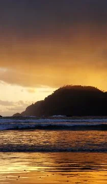 The sun sets behind the hills Stock Photos