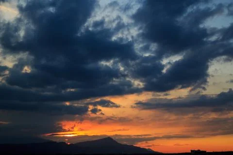 The sun sets behind the mountains. beautiful panorama and view of the setting Stock Photos