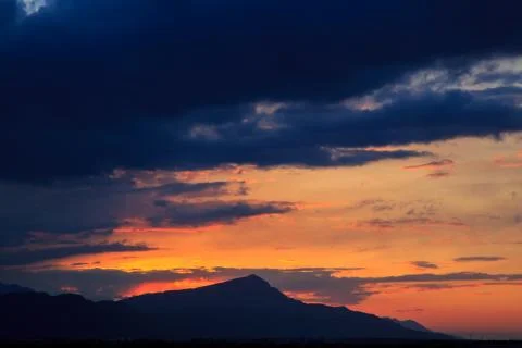 The sun sets behind the mountains. beautiful panorama and view of the setting Stock Photos