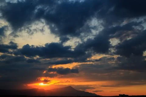 The sun sets behind the mountains. beautiful panorama and view of the setting Stock Photos