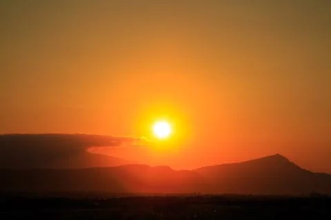 The sun sets behind the mountains. beautiful panorama and view of the setting Stock Photos