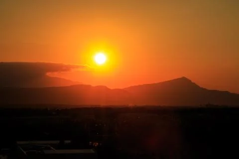 The sun sets behind the mountains. beautiful panorama and view of the setting Stock Photos