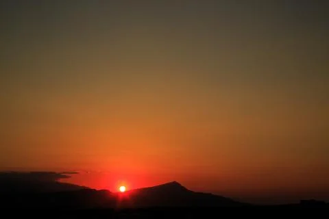 The sun sets behind the mountains. beautiful panorama and view of the setting Stock Photos