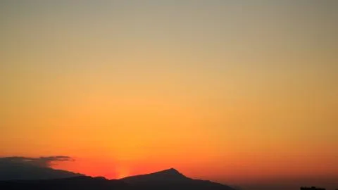 The sun sets behind the mountains. beautiful panorama and view of the setting Stock Photos