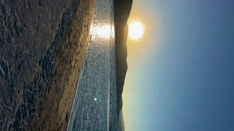 The sun sets behind the mountains on the lake. Stock Footage 252278869