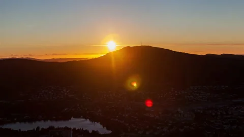 Sun sets behind the mountains silhouette, Norway, Bergen timelapse Skyline Stock Footage 233656106