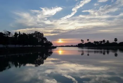 Sun sets behind the pond. Stock Photos