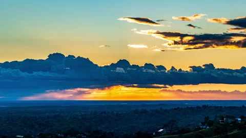 Sun Sets Behind Remnant Storm Clouds Stock Footage 282782831