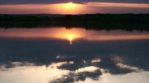 The sun sets behind the river and the forest Stock Footage 196822142