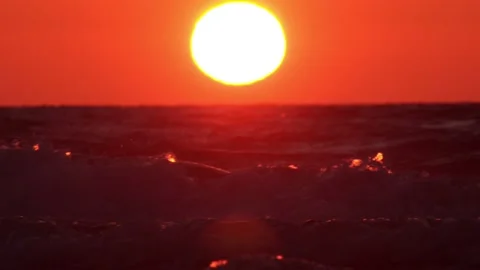The sun sets behind the sea waves Stock Footage 154191630