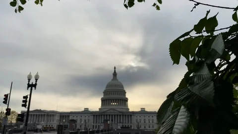 The sun sets behind the US Capitol building during the COVID-19 pandemic Stock Footage 128836246